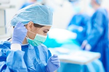 Female Doctor Putting on Mask
